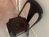 a black chair sitting in the corner of a room