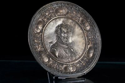 a silver plate with a picture of a man on it