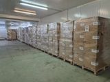 a large amount of boxes stacked on pallets in a warehouse