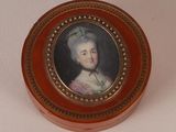 a small box with a painting of a woman on it