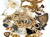 a lot of jewelry that is laying out on the table