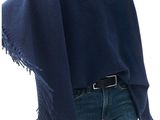 the woman is wearing a blue shawl with fringes on it