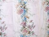 a picture of a floral curtain hanging on a wall