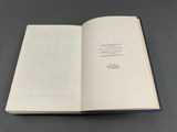 an open book sitting on top of a table next to a gray table
