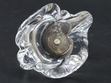a glass object that is sitting on a black surface