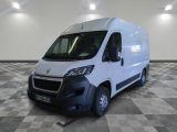 the white van is parked in a large room with checkered floor