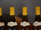 four bottles of wine are lined up on a table