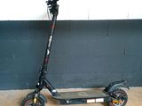 a scooter that is parked in front of a wall