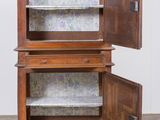 an old wooden cabinet with two doors open on a wooden floor