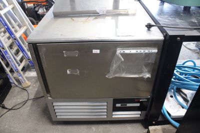 an image of a stainless steel refrigerator in a garage