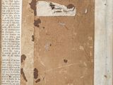 an old book with a piece of paper on top of it