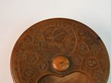 a brown plate with a heart on it on a table