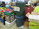 a pile of boxes and a trash can in a store