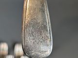 a spoon and fork that is hanging from a hook