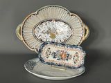 a plate with a decorative design on it and a tray with a decorative design on it