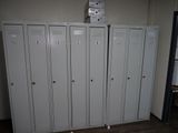 five lockers in a room with a clock on top of them