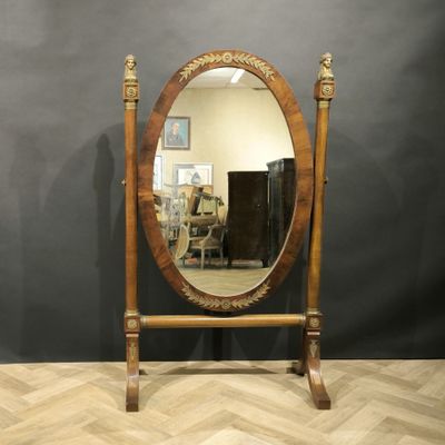 an image of a mirror sitting on top of a wooden stand