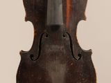 a close up of a violin on a white surface with a white background