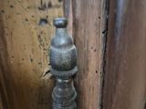 a close up of a door handle on a wooden door