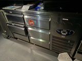 a large stainless steel kitchen with a lot of drawers