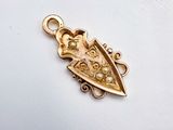 an image of a gold plated pendant with a heart on it