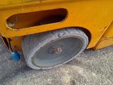 a close up of a wheel on a yellow truck