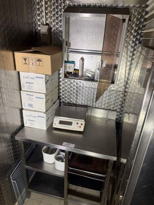 a small kitchen with a lot of boxes on the counter
