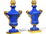 pair of blue and gold vases on wooden bases on a white background