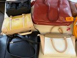 a lot of purses that are sitting on a table