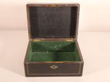 a small wooden box with a green lining inside of it