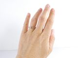 a woman ' s hand with a ring on it