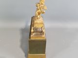 a gold statue of a man sitting on top of a box