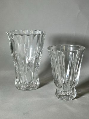 two glass vases sitting next to each other on a table