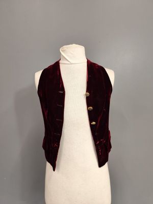 a white mannequin torso with a red velvet jacket on it