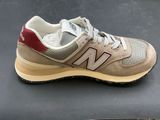 the new balance shoes are on a black surface with a red and white stripe