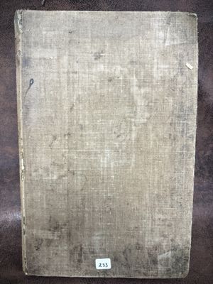 a picture of an old book on a brown surface