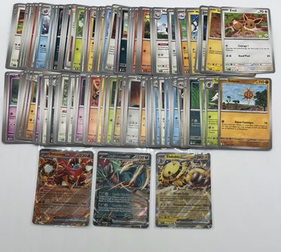 a lot of different pokemon cards on the table