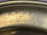 silver plate with roman numerals on the rim of it