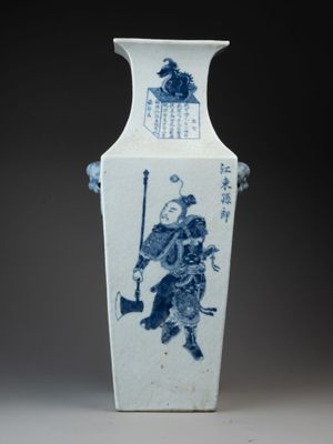a blue and white vase with a man on it