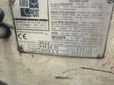 a sign on the side of a machine that is sitting on the ground