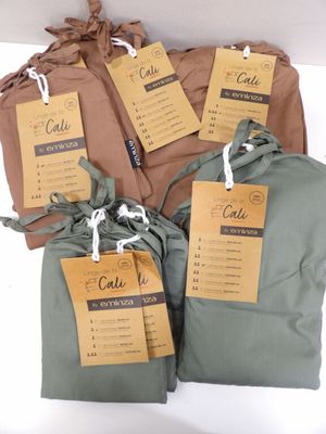 three bags with tags on them are sitting on a table