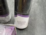 two bottles of wine sitting on a table next to a box of wine