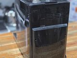 a black microwave sitting on a wooden counter top