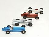 several toy cars are lined up in a row on a white surface