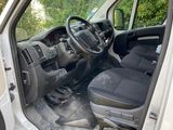 the interior of a white van with the door open and the driver ' s seat down