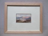 tableau représentant un paysage de montagne, dans un cadre en bois, accroché au mur