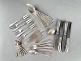 a lot of silver spoons and forks on the table
