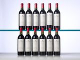 six bottles of red wine are lined up on a shelf