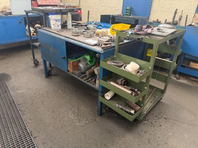 a workbench that has a lot of tools on it