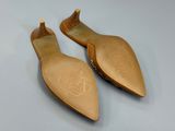 a pair of women ' s shoes on a white surface